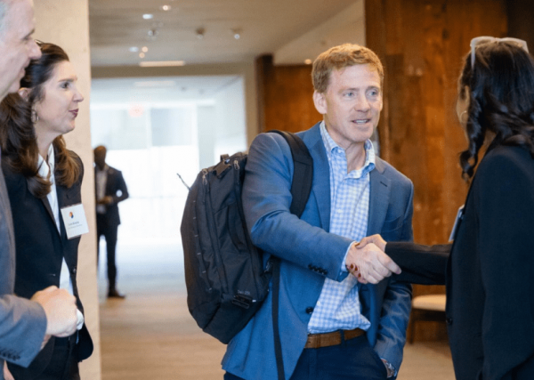 speaker-event-shaking-hands-source